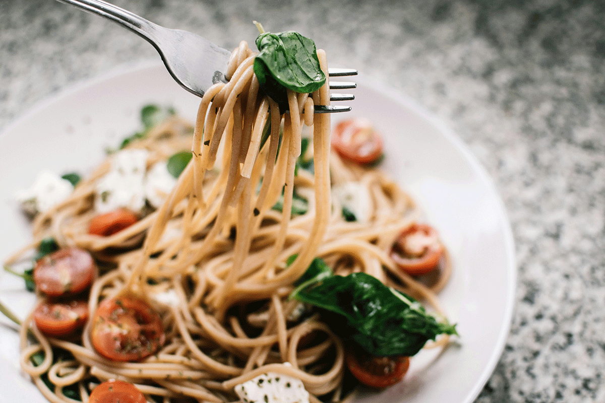 plate of noodles with basil and tomato sauce